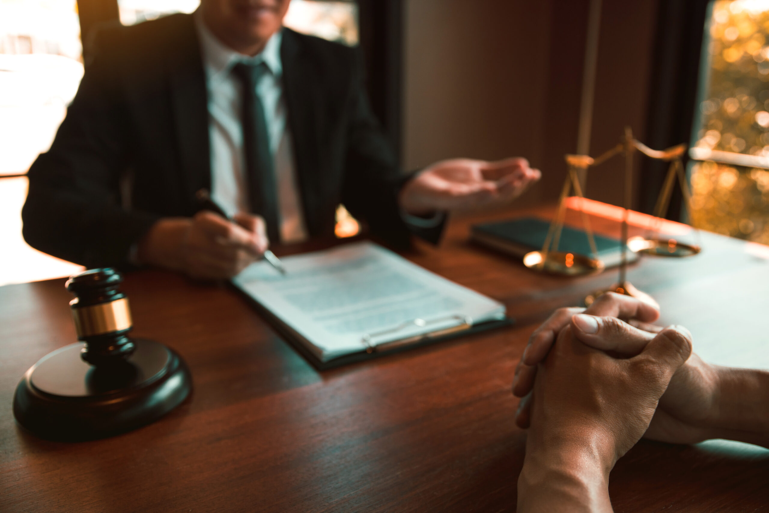 Background image of an attorney meeting with a client for a possible medication error claim